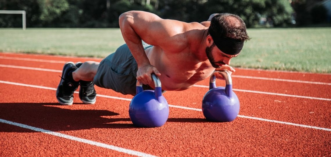 man exercising on field during daytime